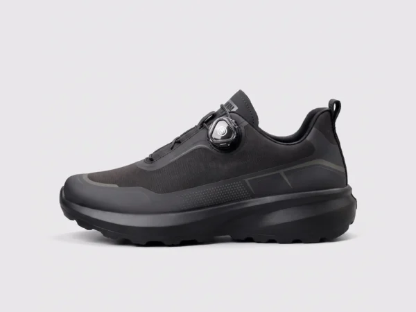 trendy rotating dial closure casual sneakers breathable chunky sole commuter shoes in black, left side profile view on a light gray background