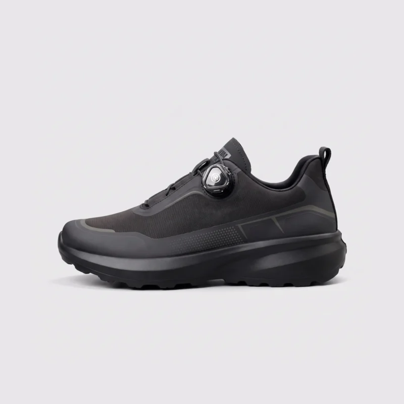 trendy rotating dial closure casual sneakers breathable chunky sole commuter shoes in black, left side profile view on a light gray background