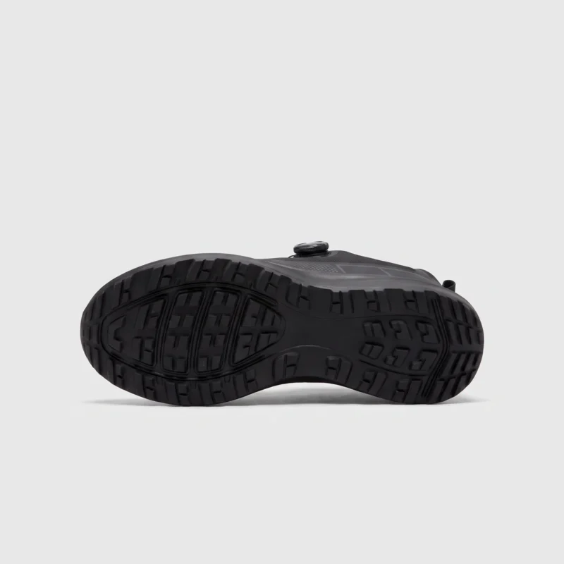 trendy rotating dial closure casual sneakers breathable chunky sole commuter shoes in black, outsole tread view on a light gray background