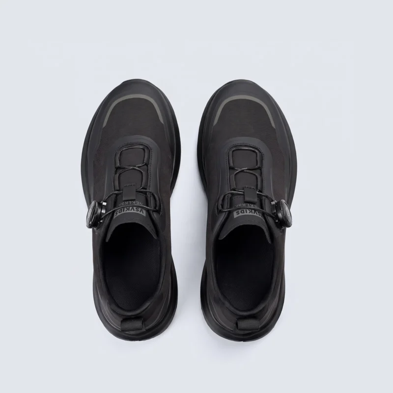 trendy rotating dial closure casual sneakers breathable chunky sole commuter shoes in black, top-down view of the pair on a light gray background