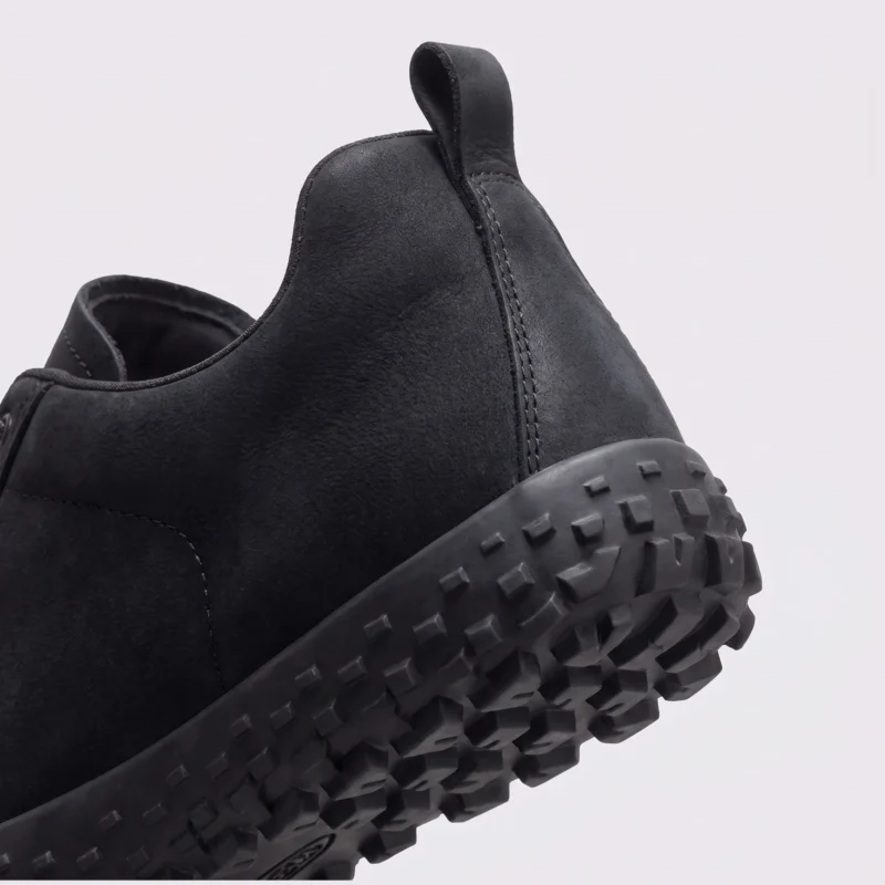 wide toe box barefoot hiking sneakers in black, close-up view of the heel on a light gray background