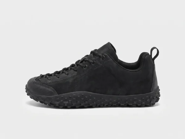 wide toe box barefoot hiking sneakers in black, left side profile view on a light gray background