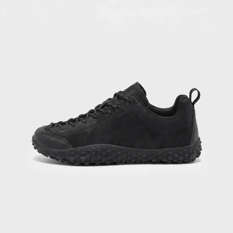 wide toe box barefoot hiking sneakers in black, left side profile view on a light gray background
