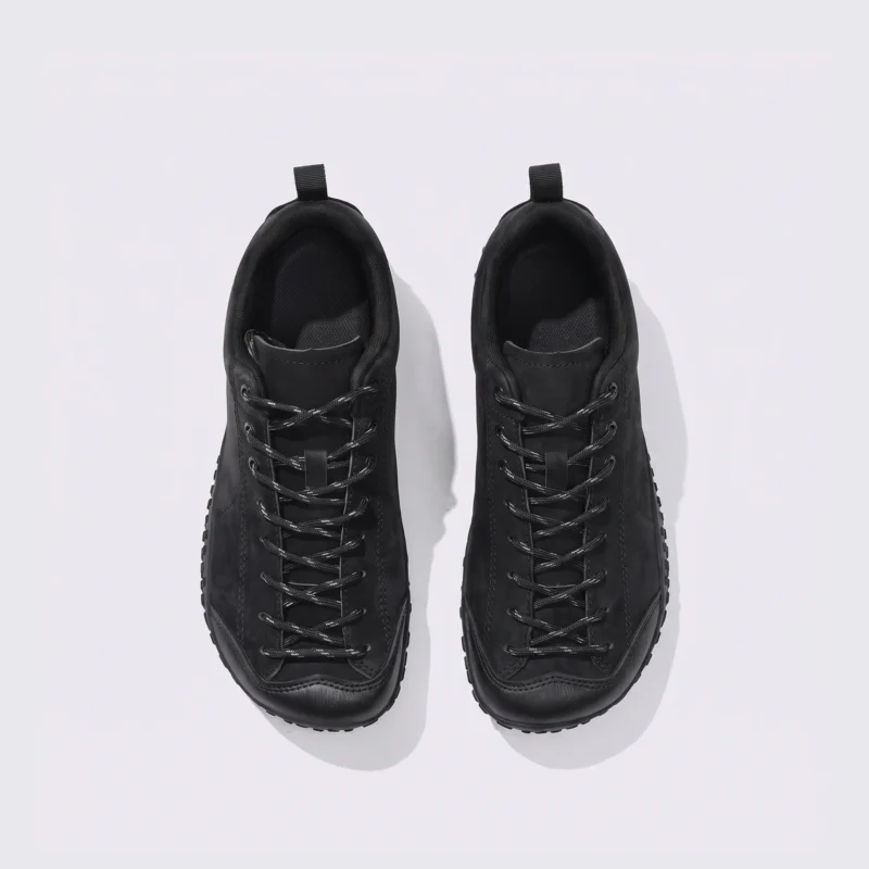 wide toe box barefoot hiking sneakers in black, top-down view of the pair on a light gray background