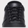 leather breathable hiking walking shoes lightweight non-slip outdoor sneakers in black, close-up view of the closure on a light gray background