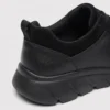 leather breathable hiking walking shoes lightweight non-slip outdoor sneakers in black, close-up view of the heel on a light gray background