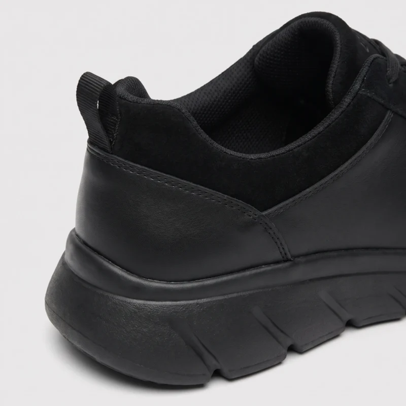 leather breathable hiking walking shoes lightweight non-slip outdoor sneakers in black, close-up view of the heel on a light gray background