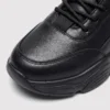 leather breathable hiking walking shoes lightweight non-slip outdoor sneakers in black, close-up view of the toe on a light gray background